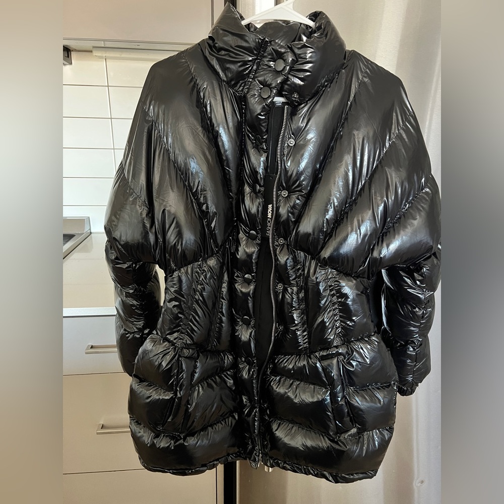 Woman all black puffer coat. Very stylish and different. Faux leather.